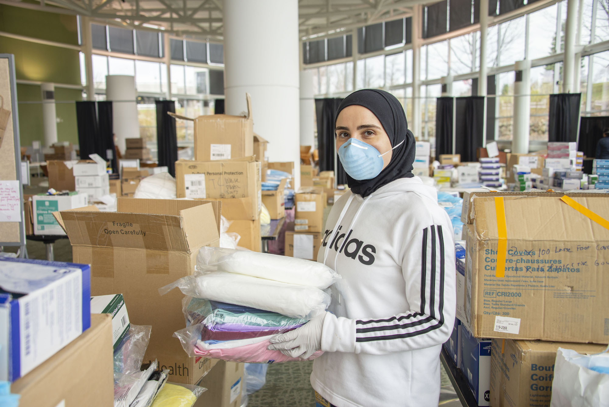 Woman sorts through donated PPE supplies at NCRC