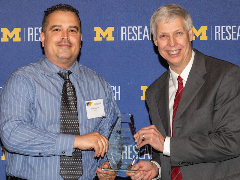 Chris Fry, Research Lab Specialist Intermediate, ULAM, receives OVPR Award from Bradford Orr, Associate VP, Natural Sciences and Engineering