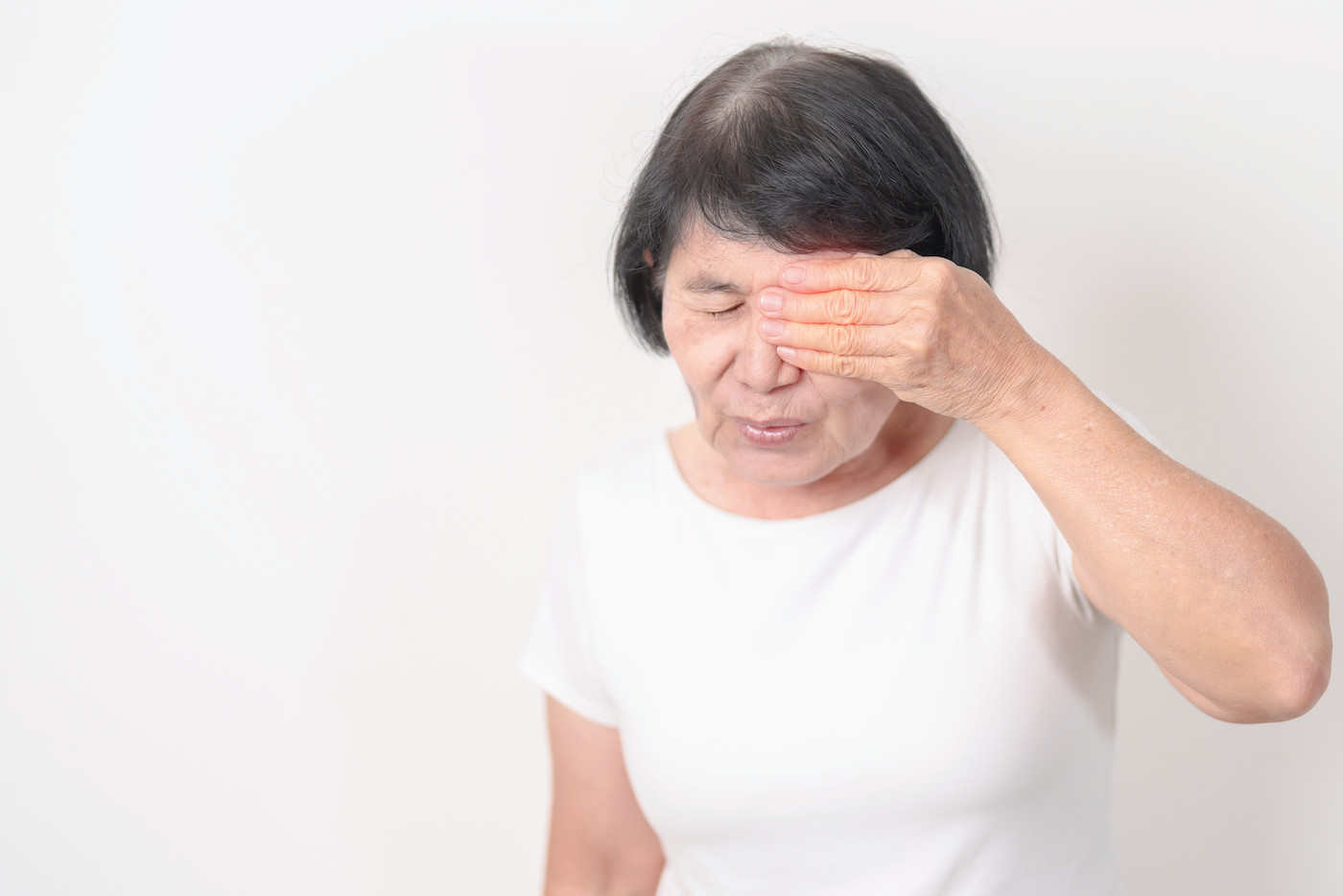Elderly woman having eye pain and irritation