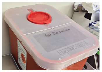 Properly labeled and maintained sharps container