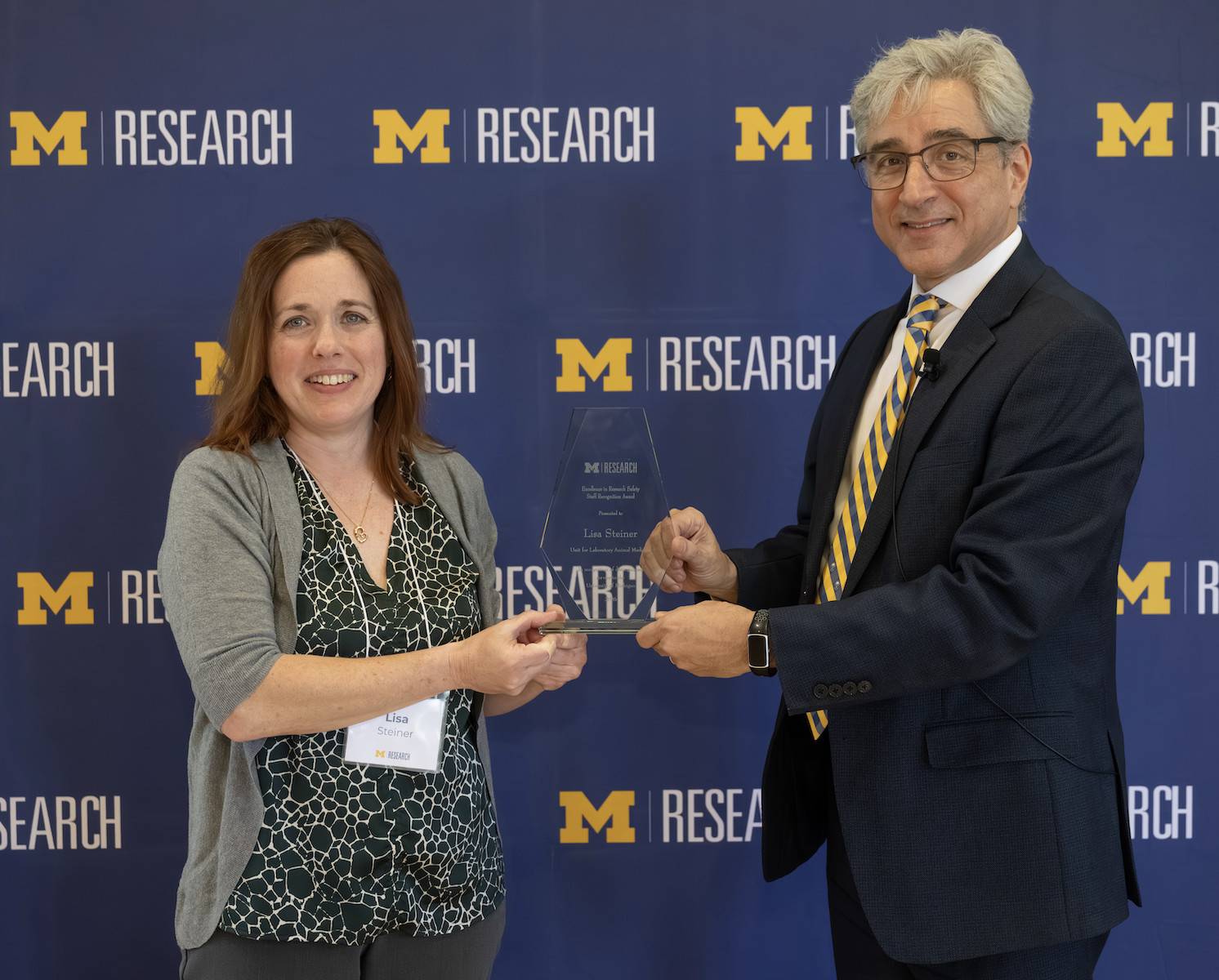 Lisa Steiner accepting award from Skip Lupia