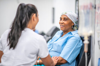Senior adult woman receives treatment in clinic from healthcare worker